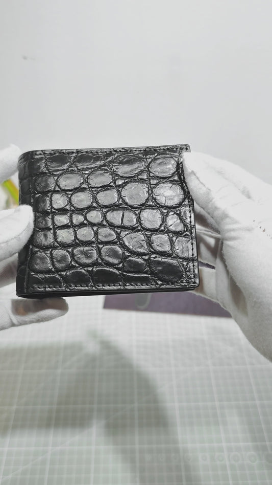 video demonstrating black genuine alligator belly leather bi-fold wallet